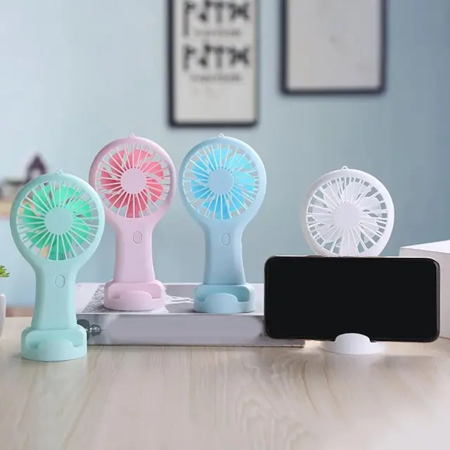 whatsapp-image-2025-04-17-at-030806-b2ab8280-973f-46ef-a8f2-b3abbc96b535-1744838183494 Mini Handy Fan Rechargeable With Stand - Image 1
